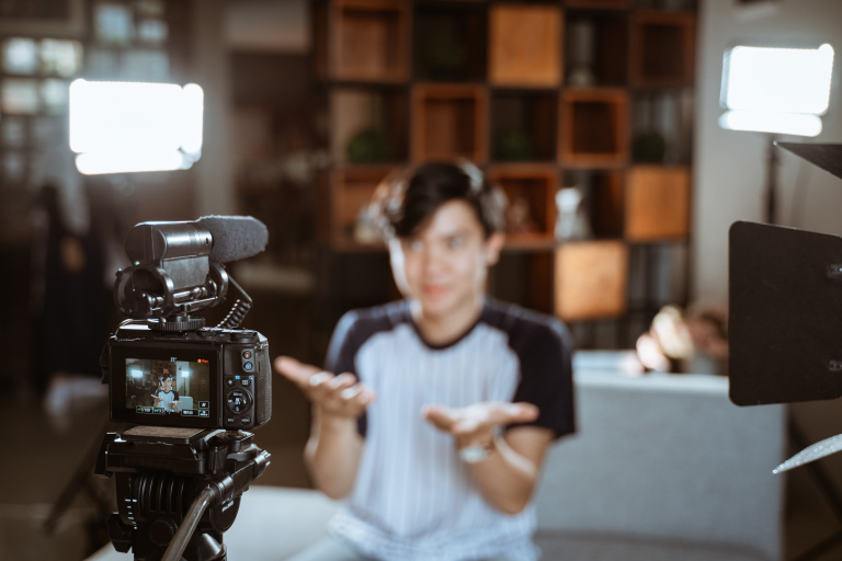 How to Look Your Best on Camera: Tips and Tricks for Perfect ShotsHow to Look Your Best on Camera: Tips and Tricks for Perfect ShotsIn today’s digital age, appearances matter more than ever, especially when you're on camera. Whether it's for a Zoom call, a professional video, a social media post, or a live stream, looking your best on camera can greatly impact how you’re perceived. While the power of digital media allows anyone to create content, not everyone knows how to present themselves in the best light. Fortunately, there are simple tips and tricks that can help you look your best on camera every time.This guide will provide in-depth advice on everything from lighting and wardrobe choices to posture and facial expressions. By implementing these tips, you'll be able to appear more polished and confident, regardless of the medium.1. Good Lighting is KeyLighting is perhaps the most crucial factor when it comes to looking good on camera. It can either make or break the entire shot. Poor lighting can cause you to appear shadowed, washed out, or overly dim, while good lighting can highlight your features and create a flattering effect.Natural Light: The best lighting is natural light. If possible, position yourself near a window with soft, diffused sunlight. Natural light gives your face a warm, healthy glow. Avoid harsh sunlight directly coming through the window, as it can create harsh shadows and make you squint.Soft Light: If you're shooting indoors without much natural light, opt for soft, even lighting. A ring light or softbox lights can work wonders. These types of lights provide even illumination across your face, reducing shadows and making your skin look more even-toned.Avoid Overhead Lights: Overhead lights often cast unflattering shadows, particularly under your eyes and chin. If you're relying on artificial light, try to position your light source at eye level or slightly above.Positioning: Place the light source in front of you, ideally at a 45-degree angle. This setup ensures that the light illuminates your face from a flattering angle, avoiding unflattering shadows or glare.2. Wardrobe Choices MatterWhat you wear plays a significant role in how you look on camera. The right clothing can enhance your features, while the wrong choice can distract or make you look washed out. Here’s how to choose the perfect outfit for your on-camera appearance:Solid Colors Over Patterns: Solid colors tend to work better on camera than busy patterns or stripes, which can cause distractions or visual distortions. Bright or jewel-toned colors often pop on screen, but avoid overly bright or neon colors, which can cause issues with exposure.Avoid White or Black: While white and black may seem like neutral choices, they can create challenges on camera. White can sometimes make you look washed out, while black can create harsh contrasts that may obscure details. Instead, try to go for mid-tone colors or softer shades that will complement your skin tone.Fit is Important: Clothes that are too tight or too loose can create an unflattering silhouette. Opt for well-fitted clothes that show off your shape without being too constricting. Clothes that move naturally with your body help create a more relaxed and comfortable look.Necklines and Accessories: Pay attention to the neckline of your clothing. High-necked tops can make you appear stiff, while a slightly open collar can create a more flattering, relaxed look. Simple, minimal accessories work best, as they won’t distract from your face.3. Framing Your ShotThe framing of your shot is also a key element in looking your best on camera. Improper framing can make you appear too distant, awkwardly cropped, or poorly aligned in the frame. Here’s how to position yourself for the best results:Eye Level: Position the camera at or just above eye level. Looking directly into the camera lens at eye level creates a sense of connection and confidence. Avoid looking up or down at the camera, as this can cause distortion and a less flattering angle.Center Your Face: Make sure that your face is centered in the shot. You should be positioned so that your eyes are approximately one-third of the way down from the top of the frame. This creates a balanced and professional look.Avoid Too Much Headroom: Don’t leave excessive space above your head. Too much empty space can make you look small and distant. Ideally, your head should be closer to the top of the frame, leaving just a little room above.Head and Shoulders: A shot that includes your head and shoulders is the most flattering for most camera types. This framing gives a clean view of your face while maintaining a professional, approachable appearance.4. Facial Expressions and PostureBody language and facial expressions are powerful tools when you’re on camera. They can help convey confidence, warmth, and approachability. Conversely, poor posture or a lack of expression can give off an impression of disinterest or discomfort.Smile Genuinely: A natural, warm smile can make you seem friendly and engaging. Practice smiling in a way that feels comfortable—avoid forced or exaggerated smiles, as they can appear inauthentic.Posture: Sit or stand up straight to project confidence. Slouching makes you appear less engaged and can affect how your body looks on camera. Keep your shoulders back, and avoid crossing your arms, as this can look defensive or closed off.Eye Contact: Maintaining good eye contact is essential for creating a connection with your audience. Look directly into the camera lens, not at the screen or your own reflection. This makes the interaction feel more personal and engaging.Stay Relaxed: Tension in your face, hands, or body can show on camera, making you appear nervous or stiff. Take a deep breath, relax your face, and try to be as comfortable as possible.5. Camera Angle and DistanceYour camera angle and distance from the lens affect how you appear to your audience. A good angle helps create a flattering look and avoids any unintended distortions.Avoid Extreme Angles: Shooting from below or above can create unflattering perspectives. A low angle can make your face look larger, while a high angle can make your eyes appear smaller. Ideally, position the camera at or just above your eye level.Distance from the Camera: Avoid being too close to the camera, as it can distort your features. Conversely, being too far away can make you look small or disconnected. Aim for a moderate distance—typically from the waist up—for a more natural and engaging appearance.6. Makeup and GroomingA little grooming can go a long way when it comes to looking good on camera. While you don't have to wear heavy makeup or get a professional haircut, certain adjustments can enhance your appearance.Makeup: Even if you don't usually wear makeup, a light application can help even out your skin tone and reduce shine. Use a matte powder to control excess shine, and choose neutral tones for eyeshadow, blush, and lipstick. Foundation or concealer can help smooth out any blemishes or uneven skin tones.Hair: Make sure your hair is neatly styled and away from your face. If you have long hair, consider tying it back or keeping it tucked behind your ears to avoid distractions. If you have short hair, make sure it’s well-groomed and styled.Facial Hair: If you wear facial hair, make sure it is neatly trimmed. A messy beard or mustache can distract from your face, so regular grooming is key to maintaining a sharp, polished look.7. Avoid Distractions in the BackgroundThe background of your shot can either enhance or detract from your appearance on camera. Make sure the area behind you is clean and uncluttered.Neutral Background: Choose a neutral, tidy background that doesn't distract from your face. A simple, solid-colored wall, bookshelf, or well-organized space works well.Virtual Backgrounds: If you’re working with a virtual background (for example, during a Zoom meeting), make sure it’s professional and not too busy. Virtual backgrounds with excessive patterns or images can appear unprofessional and may distract from the conversation.8. Sound Quality MattersWhile sound isn’t a visual factor, it’s critical to ensure your audio is clear and of good quality. Poor sound can undermine an otherwise perfect video. Consider using an external microphone or a good-quality headset for the best sound quality.---Frequently Asked Questions1. How do I make my face look better on camera without makeup?Use proper lighting to highlight your face and smooth out skin tone. A ring light or softbox can create a natural, glowing effect. You can also apply a mattifying powder to reduce shine and use a bit of concealer to hide blemishes if needed.2. Should I wear glasses on camera?Glasses can reflect light and create glare on camera. If you wear glasses, make sure they're clean and have an anti-glare coating to minimize reflection. Alternatively, you can wear contacts for a clearer look.3. How do I look natural on video?Relax, smile, and avoid stiff body language. Maintain a comfortable posture and engage with the camera as if you were talking to a friend. Use natural hand gestures and make sure your facial expressions align with the tone of the conversation.4. How do I make my Zoom background look better?Choose a simple, clean virtual background that doesn't distract from your appearance. If you're using a real background, ensure it’s neat and uncluttered.5. Can I use filters to enhance my appearance?Filters can help smooth out skin imperfections, but use them sparingly. Overusing filters can make your appearance look artificial and may detract from your natural beauty. It's best to use them for a subtle touch-up.---ConclusionLooking your best on camera is about more than just how you look—it's about presenting yourself confidently and professionally. With the right lighting, wardrobe, and attention to detail, you can improve how you appear on screen and make a lasting, positive impression. Whether you’re filming for work, social media, or personal purposes, following these tips will help you look polished and poised in front of the camera.